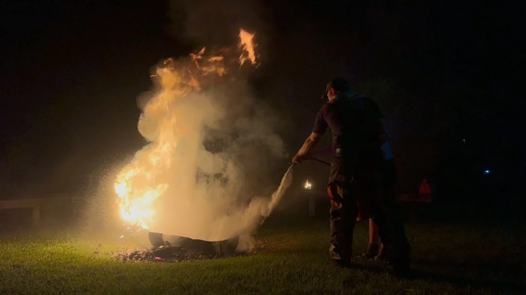 Josh, a first responder putting out a fire during a training course.