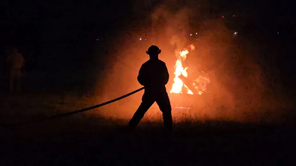 Josh, a first responder putting out a fire during a training course.